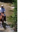 charles riding in creek