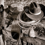 cowboy saddle hat wood fence